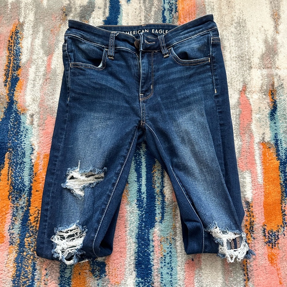 American Eagle Dark Wash Skinny Jeans Size 4 with holes.